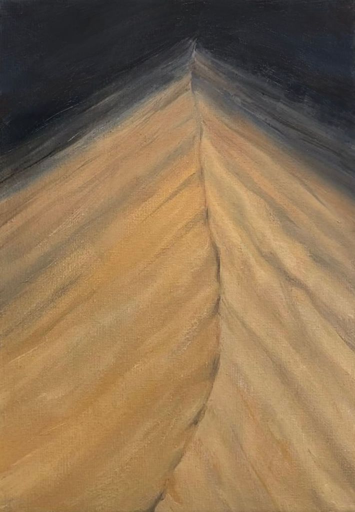 A close view of a desert dune crest painted in muted golds and greys, rising toward a darkened sky. Wind-shaped ridges run diagonally across the sand, converging at a narrow peak, suggesting stillness, pressure, and ascent.